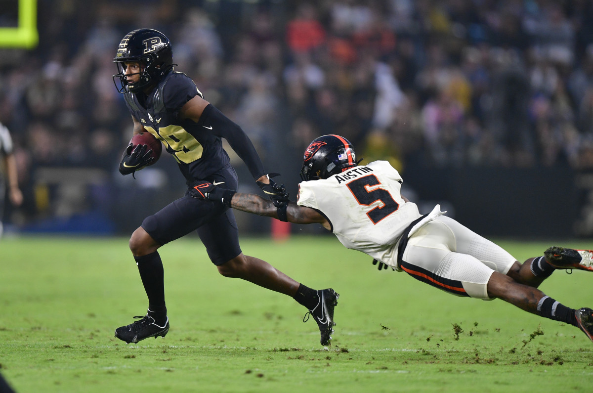 Purdue wide receiver Broc Thompson (29) jukes Oregon State defensive back Alex Austin (5).